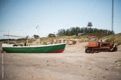 A heavy bulldozer pulls a fishing boat out of the sea, Jurmalciems, Latvia.