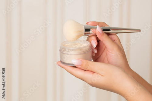 Female hand holding loose powder