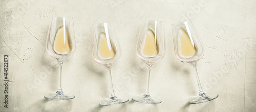 White wine in glasses on a concrete background, panorama. Top view, flat lay.