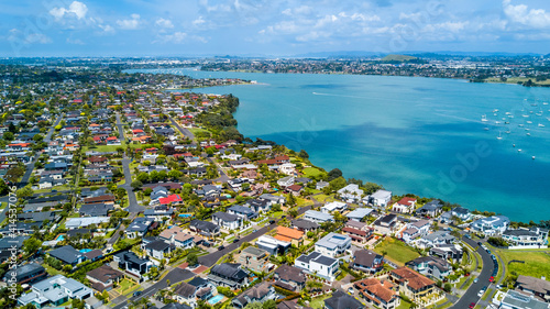 Aerial view of residential houses on a shore of a beautiful. Auckland, New Zealand.