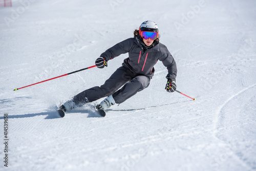 Young woman skiing on a sunny day in Andorra.