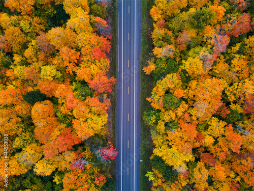 Autumn drive through the tunnel of Trees in Michigan Upper Peninsula UP - Highway 41 M26 Aerial view