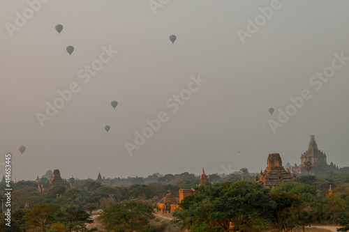 view of a scenic sunrise with many hot air balloons above Bagan in Myanmar. Bagan is an ancient city with thousands of historic buddhist temples.