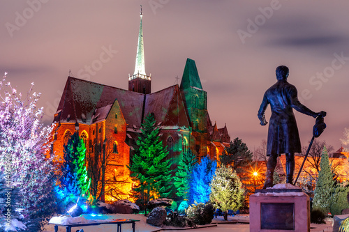 beautiful evening park with a church with illuminated trees wroclaw poland