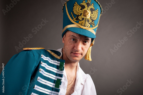 Drunken Russian hussar on gray background