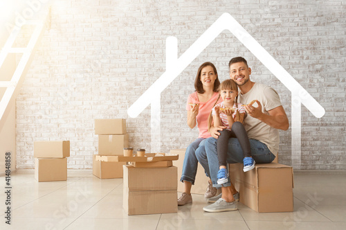 Happy family with cardboard boxes in their new house