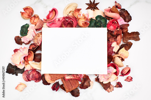 Empty white cardboard on dry colored leaves for invitations
