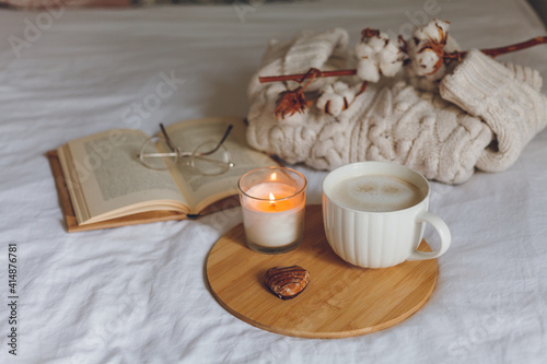 Breakfast in bed. Coffee mug, heart-shaped cookies, book, glasses, candle, wooden tray. Women's Day. Cozy.