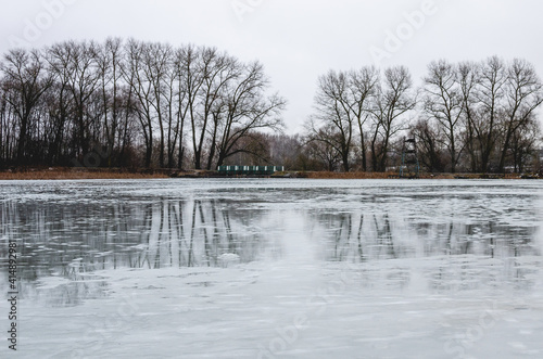 Frozen lake in early spring. Ice hasn't melted yet, cloudy day in early spring