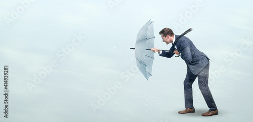 Businessman defying strong headwind