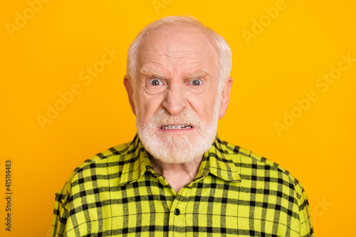 Photo of angry old man pensioner unhappy mad crazy conflict disagreement isolated over yellow color background