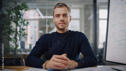 Point of View from Camera with Handsome Young Project Manager Making a Video Call in Creative Office Environment. Happy Caucasian Male Specialist Talking to Colleague Over a Live Camera.