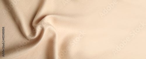 Beige soft cashmere fabric as background, closeup view with space for text. Banner design