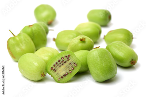 mini kiwi baby fruit (actinidia arguta) on white background 