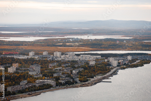 Autumn Panoramic view of the northern city of Monchegorsk, located among the mountains, taiga forest and many lakes. Orthodox Cathedral in the foreground. Kola Peninsula, Russia