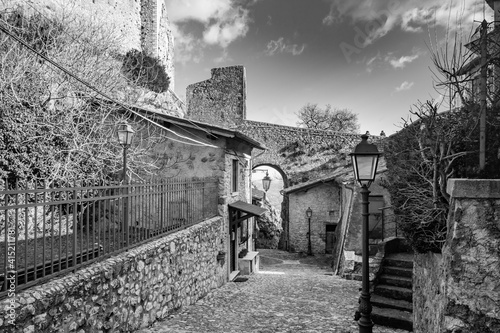 February 12, 2021 - Castel San Pietro Romano, Lazio, Rome, Palestrina - A glimpse of the medieval village, with the cobbled alley between the houses. The arch formed by the stone bridge of the castle.