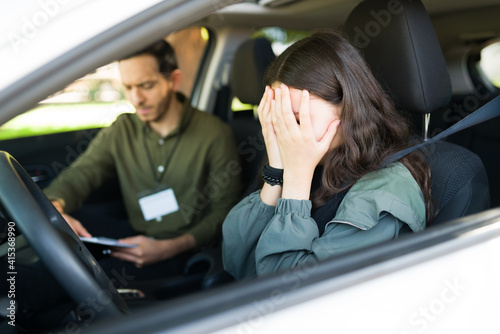 Upset teenage girl crying in the car because she failed the test