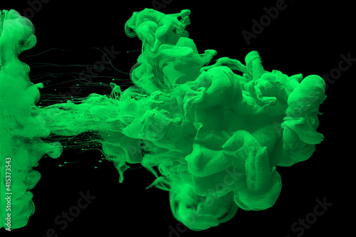acrylic ink in water form an abstract smoke pattern isolated on black background