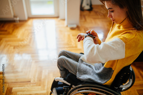 Female in wheelchair checking her smart watch