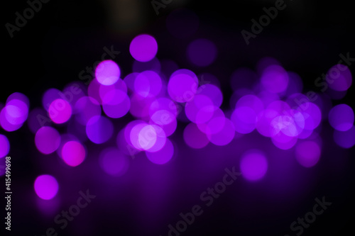 Bright purple bokeh lights on black background