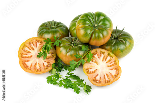 Rare raf type tomatoes, with an intense flavor and peculiar appearance, whole and cut in half. Isolated on white background. Copy space.