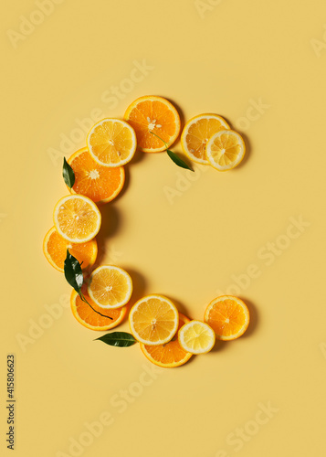 Citrus fruit food, orange and lemon shape of vitamin c flat lay on yellow background