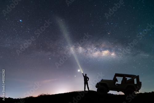 the car over the beautiful, wide blue night sky with stars and Milky way galaxy. Astronomy, orientation, clear sky concept, and background.
