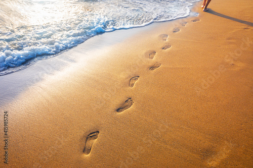 footprints on tropical beach and beautiful wave