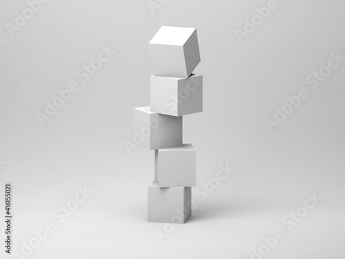 Abstract tower installation of five white cubes in an empty studio