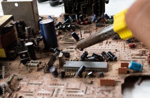 electronic circuit with capacitors transistors and resistors being repaired