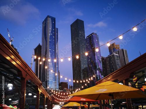 Melbourne's famous Summer Night Market selling only ethnic food and drink - every Wednesday at Victoria Market. Melbourne Cityscape background.