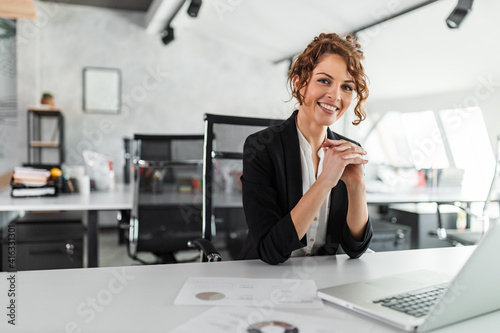 Portrait of a happy manager at bright office.