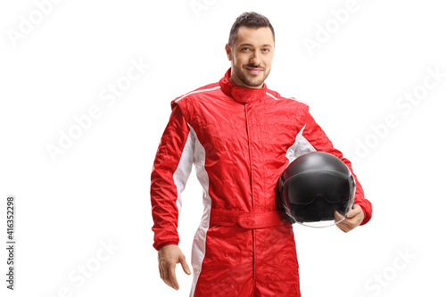 Man racer in a red uniform holding a helmet and smiling