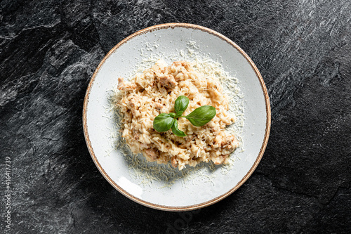 Delicious risotto with chicken stone background