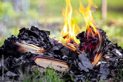 Burning books outdoors, barbaric treatment of books