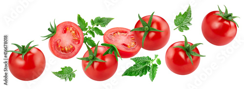 Flying tomato with green leaves isolated on white background