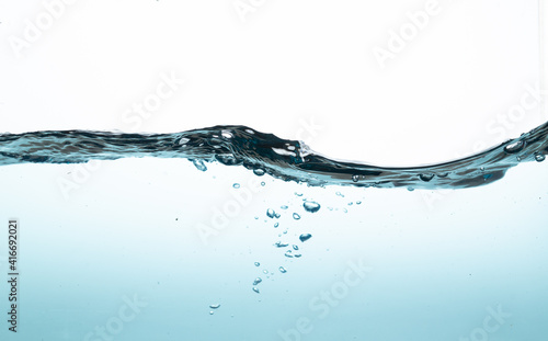 light blue water splash with bubbles of air, isolated on the white background. Giving a clear and clean feeling movement of the waves