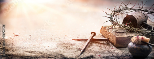 Passion Of Jesus Christ - Hammer And Bloody Nails And Crown Of Thorns On Arid Ground With Defocused Background