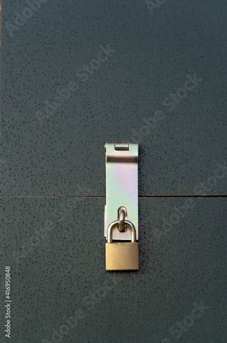 Galvanised steel door hasp lock with padlock made of brass.
