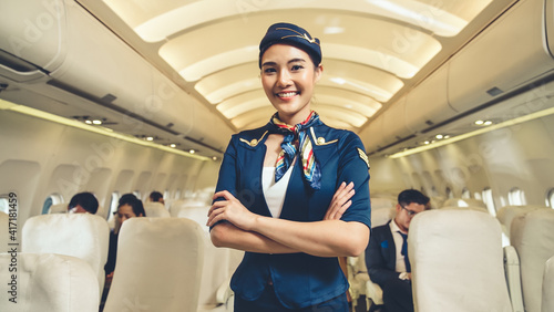 Cabin crew or air hostess working in airplane . Airline transportation and tourism concept.