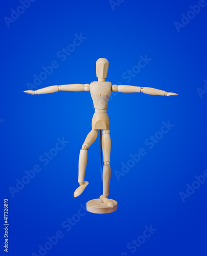 Sports wooden toy figure on blue