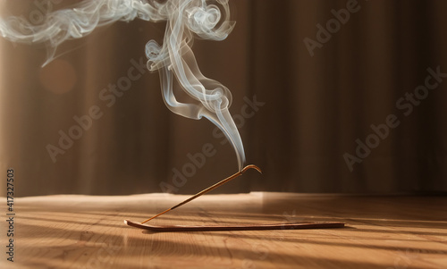 Burning aromatic incense smoky stick for meditation and relaxing. Aromatherapy smoke for yoga concept.