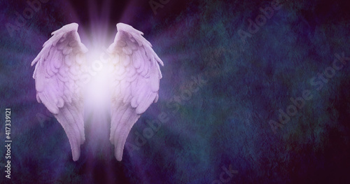 Rustic Angel Message Background - purple tinged angel wings with glowing light centre on a dark blue stone effect textured background with plenty of space for text 