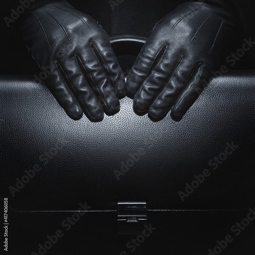 Black leather gloves. Briefcase in black leather. Business style.