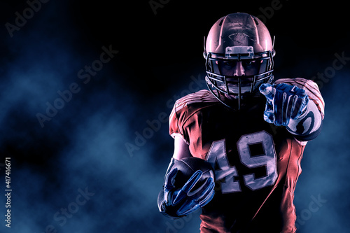 Football Player with a orange uniform coming out of a stadium tunnel.