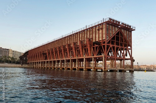View at sunset of an iron ore loading dock built in 1904 by The Alquife Mines and Railway Company Limited, known as Cable Ingles, an example of engineering work of iron architecture
