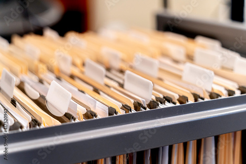 Hanging files in filling cabinet in an office