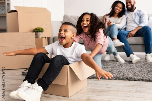 Happy African American family celebrating moving day in new apartment