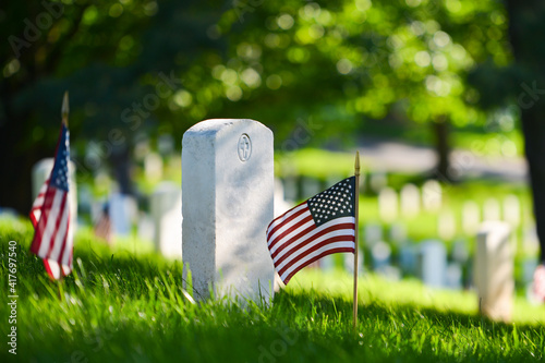 Headstones and National flags in Arlington National Cemetery - Circa Washington D.C. United States of America 