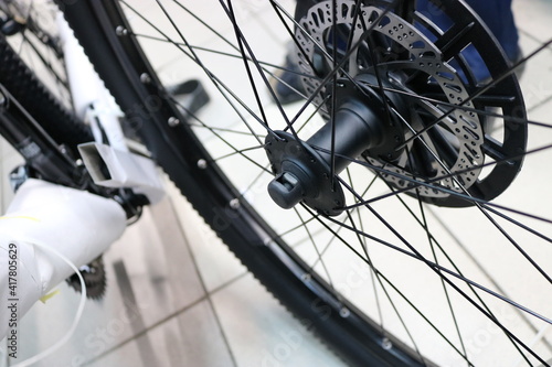 New bicycle wheel with disc brakes at a sports store. Pre-sale preparation.
